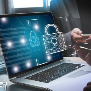 Laptop displaying digital padlocks, representing cybersecurity and data protection.