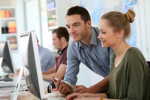 Coworkers working on computer